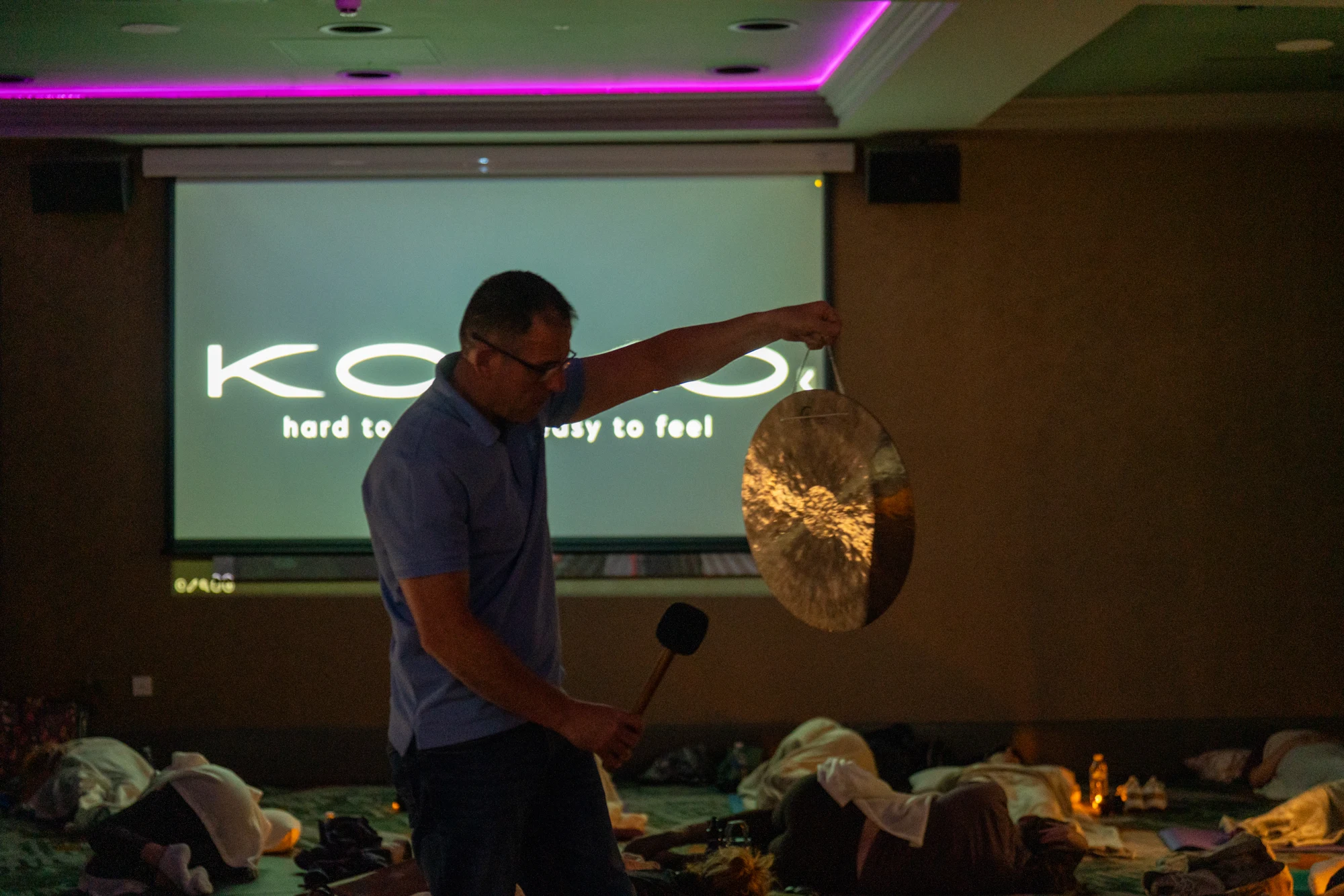 Scottish Gongsta playing a handheld gong, shown in full